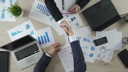 Business Meeting with Handshake on Contract
