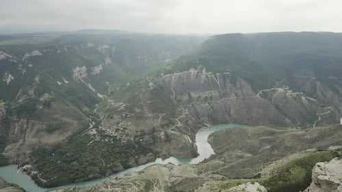 Aerial Flying Up Shot of Mountain River Flowing Between the Mountains Covered with Forest