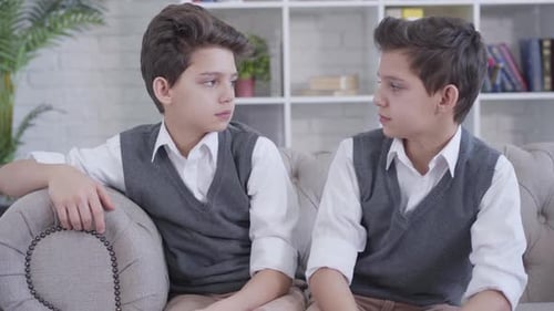 Two Young Boys in Sweater Vests Smile