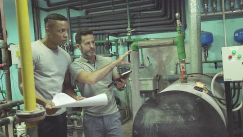 Industrial plant workers at work