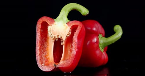 Vibrant Red Bell Peppers Against Black Background