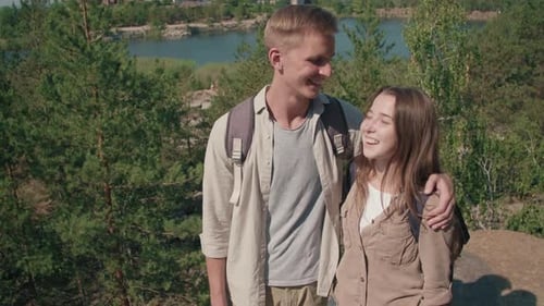Smiling Couple Embrace on Tropical Hilltop