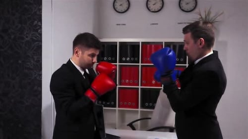 Two Competitors Colleagues Boxing in Business Centre Office