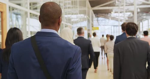 Crowd of Business People Walking Indoors Together