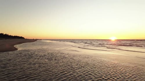 Aerial Low Flight: People Enjoy Scenic Sunset on Baltic Sea