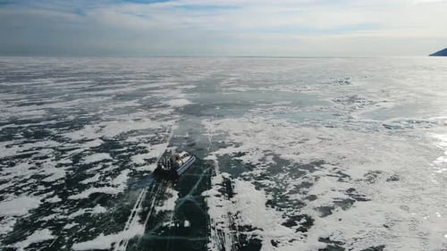 Hovercraft Glides Across Frozen Lake in Winter