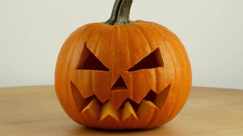 Preparing for Halloween. Pumpkin carving as a holiday decor. Pumpkin close-up 4K video.