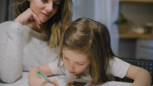 Little Girl Drawing with Her Mother at Home