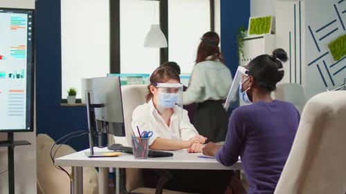 Team Collaboration in Modern Office with Safety Measures