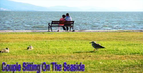 Loving Couple Sitting by the Water Relaxing Together