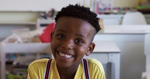 Happy Boy Smiling in Classroom Setting