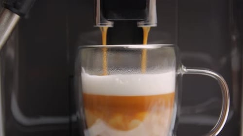 Coffee Machine Dispenses Warm Latte into Glass Mug