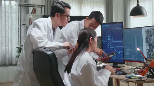 Team of Engineers Inspect Computer Components