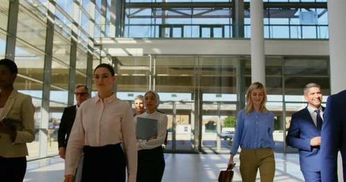 Multi ethnic business people walking together in the lobby at office 4k