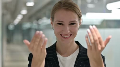 Woman Invites with Gestures in Corporate Setting