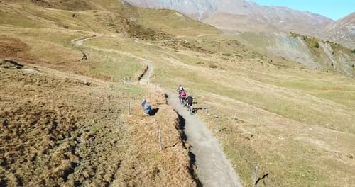 Aerial drone view of a group of mountain bikers on a singletrack trail.