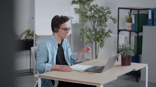 Young Adult Attending Virtual Meeting in Office