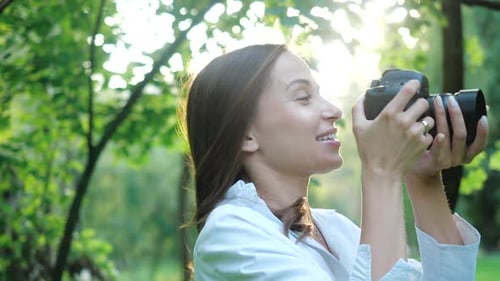 Pretty Smiling Woman Wedding Photographer Wearing White Shirt Is Making Photos with Professional
