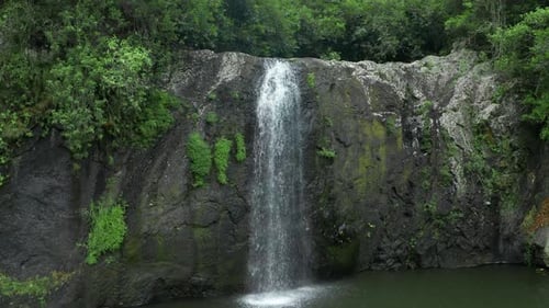 Camera is Flying Above Waterfall in Tropical Forest