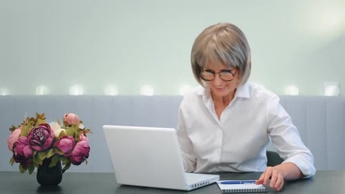 Excited Woman Celebrates Success at Desk