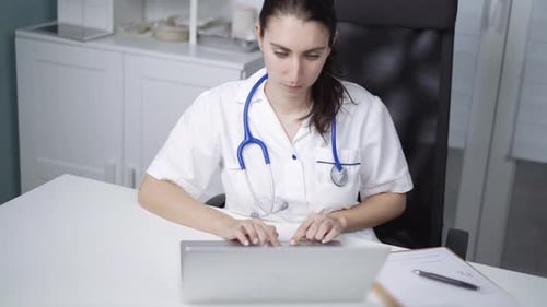 Physician working in clinic desk