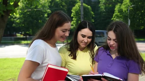 Three Students Collaborating and Writing Together