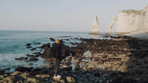 Freelance Male Photographer Taking Pictures of Stunning Sunny Normandy White Arch Cliffs on Sea