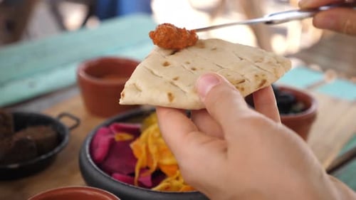 Spreading Spreads on Pita Bread Close Up