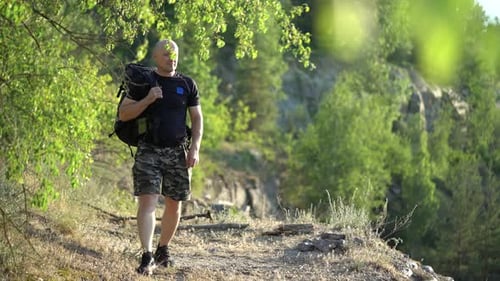 Man Hiking in Nature, Shielding Eyes