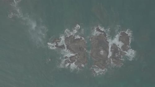 Waves Crash Against Rocks in the Ocean