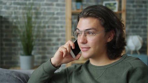 Young Adult Talking on the Phone Indoors
