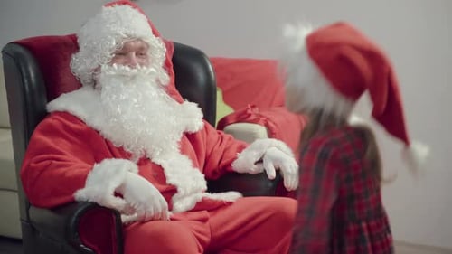 Santa Giving Christmas Present to Child at Home