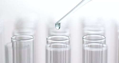 Clear Liquid Dripping From Pipette Into Test Tube