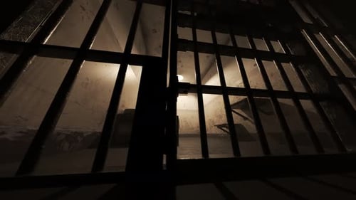 View of the old grunge prison cell interior seen through jail bars. Bottom view.