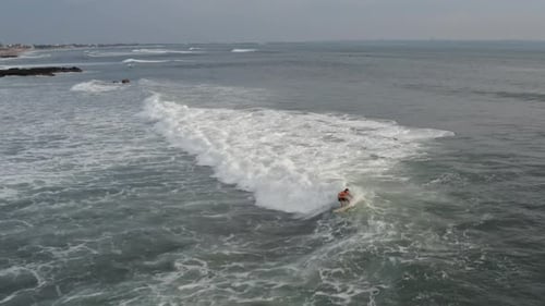 Aerial View of Surfer Riding Blue Ocean Wave. Drone Shot Surfing Ocean Lifestyle, Extreme Sports