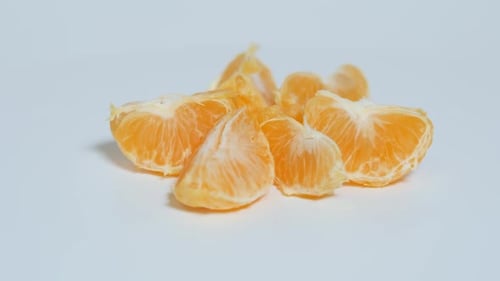 Fresh Tangerine Segments Close Up on White