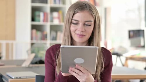 Woman Using Tablet in Office or Home Setting