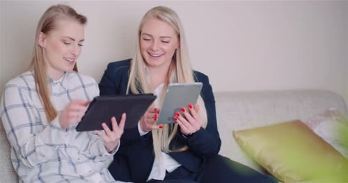 Businesswomen Discussing Over Technologies In Office