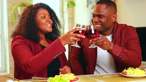 Loving Couple Toasts with Wine During Romantic Meal