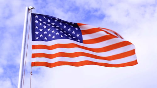American Flag Waving Proudly Against a Bright Sky
