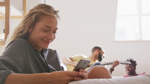 Friends Relaxing Indoors with Music and Technology