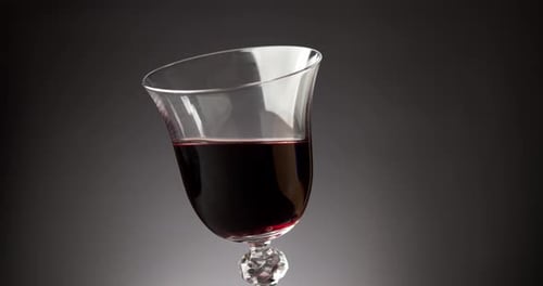 Red Wine in a Shiny Glass on a Black Background