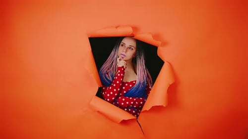 Woman with Braids Thinking Through an Orange Hole