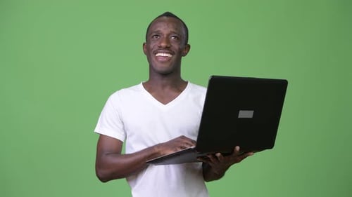 Man Holding Laptop on Green Screen Background