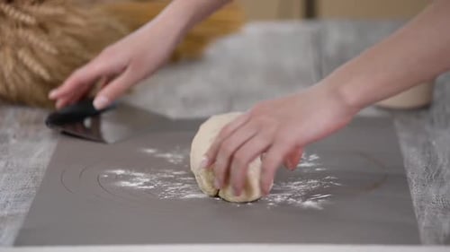 Professional Baker Divides the Dough Into Portions. Process of Making Bread at Kitchen.