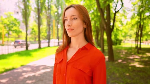 Young Pretty Woman Walking in Summer Park