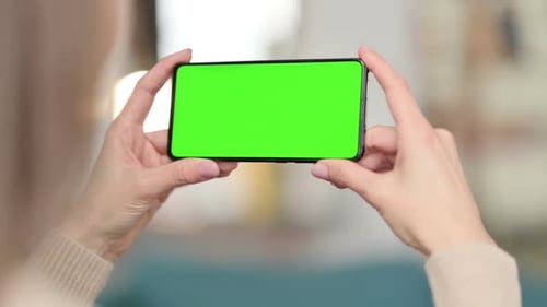 Woman Watching Smartphone with Green Screen Chroma Screen