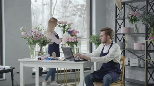 Flower Delivery, Young Modern Professional Florists Work in Blossom Store and Take Orders By Phone