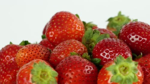 Pile of Red Strawberries Rotating in Studio Light