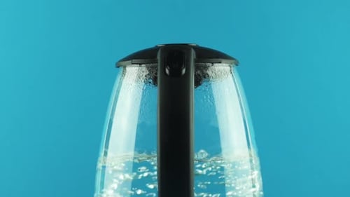 An Electric Kettle with Transparent Walls. Process of Boiling. Switch. Close-up